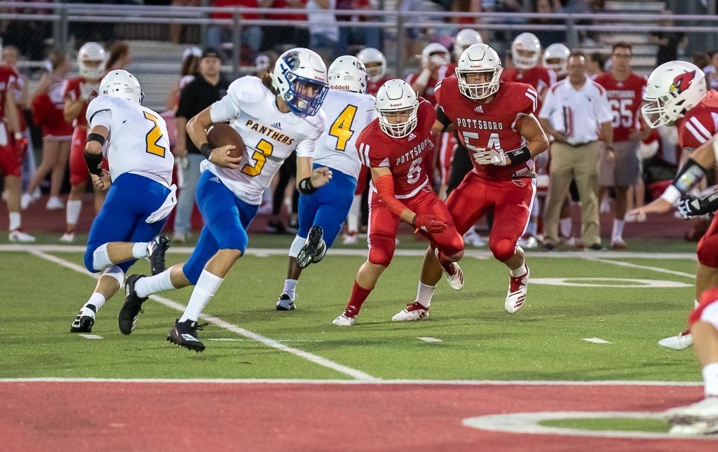 Photo by Kevin Watson: Trenton Smith (3) takes a handoff from Kobey Emeyabbi (2) against Pottsboro Friday night.