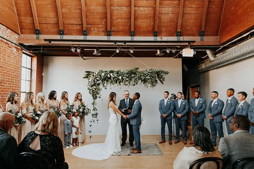 Holloway House event venue with vaulted wood ceiling, skylights, and wedding ceremony setup