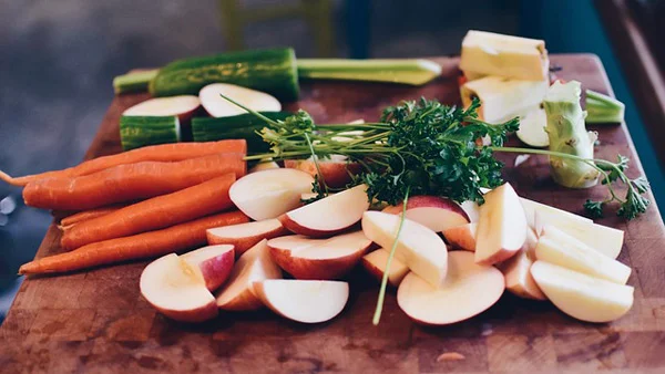 Children in a Montessori classroom learn basic food preparation as a life skill.