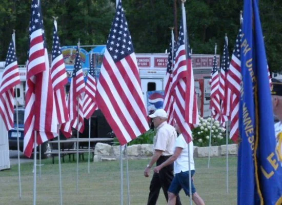  Bell of Honor Committee members Dale Wellick and Dorothy Denny placing flags. 