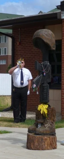  Legion member plays taps at the end of the ceremony. 
