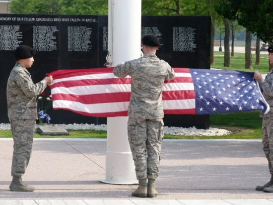  Cadets at Memorial folding the American Flag after the memorial Service. 