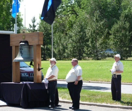  Bell of Honor tolled 7 times for the fallen after all of the names were read. Bell of Honor Committee members (L-R): Dick Denny, Scott Smith and Dale Wellick played Taps. 
