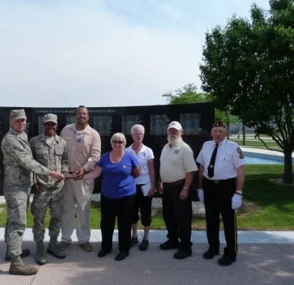  Bell of Honor Committee presents Bell of Honor Plaque to the Air Force Academy (L-R): Terry Throndson, Chaplin Mui Zebuln Beck, Cadet Matthieu Caldwill Reudn, Harry J. Lundy, Sandra Sabin, Dorothy Denny, Dick Denny and Dale Wellick. 