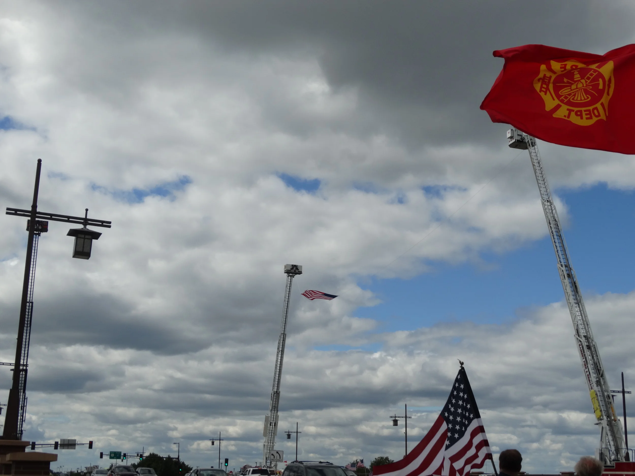  Fire trucks used their ladder trucks to suspend the American Flag 