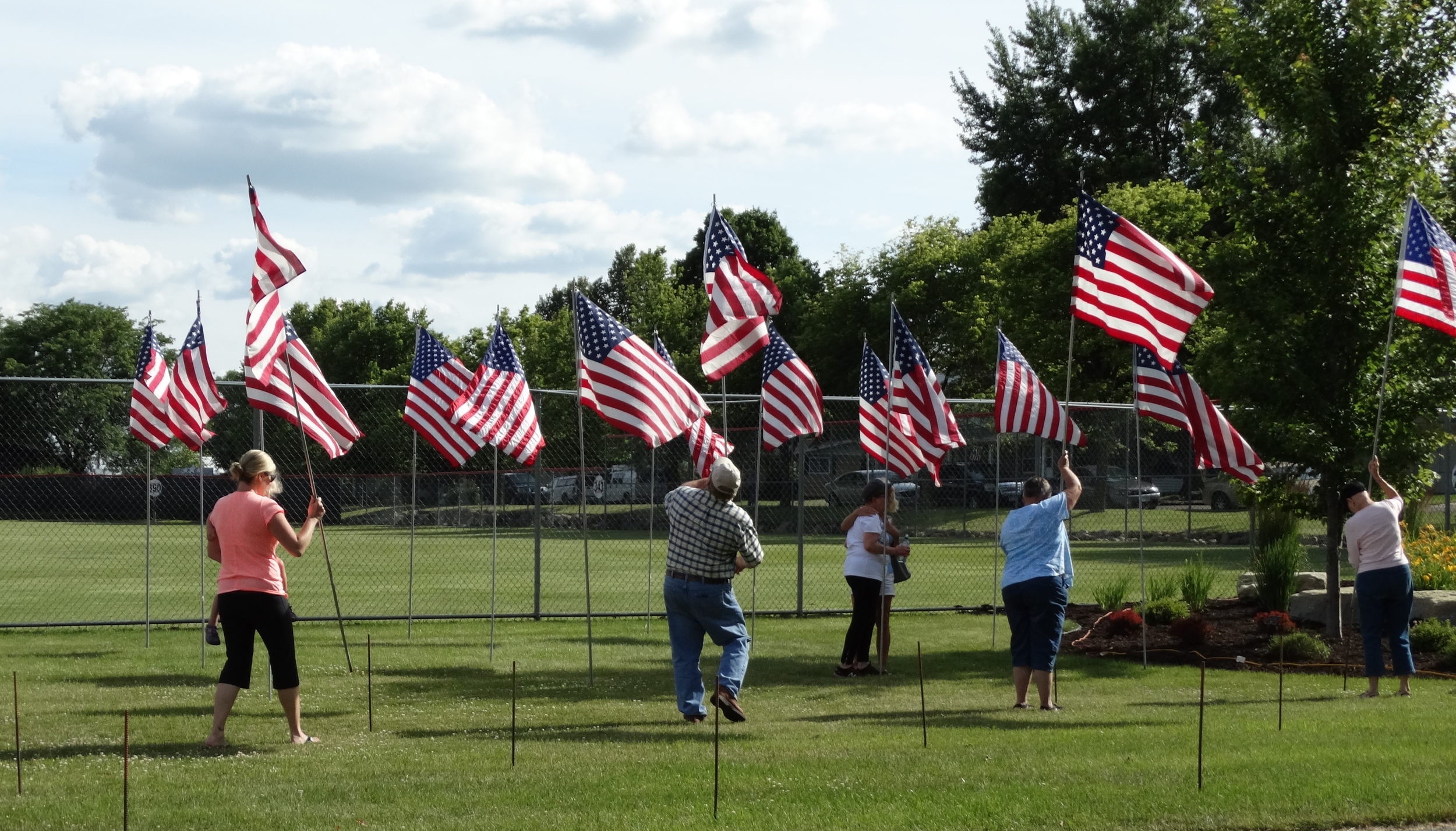 Public assists with posting all the American Flags