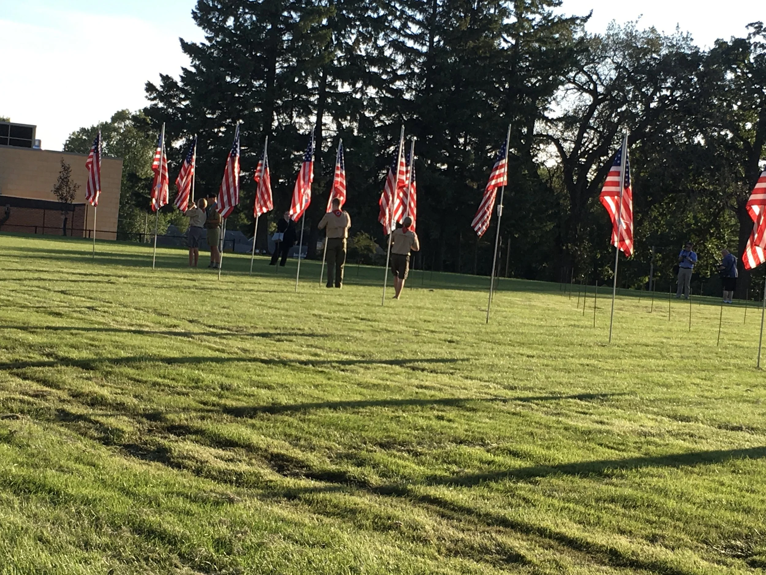  Flags being placed by Boy Scouts, Police, Sheriff, EMS and family members who attended 