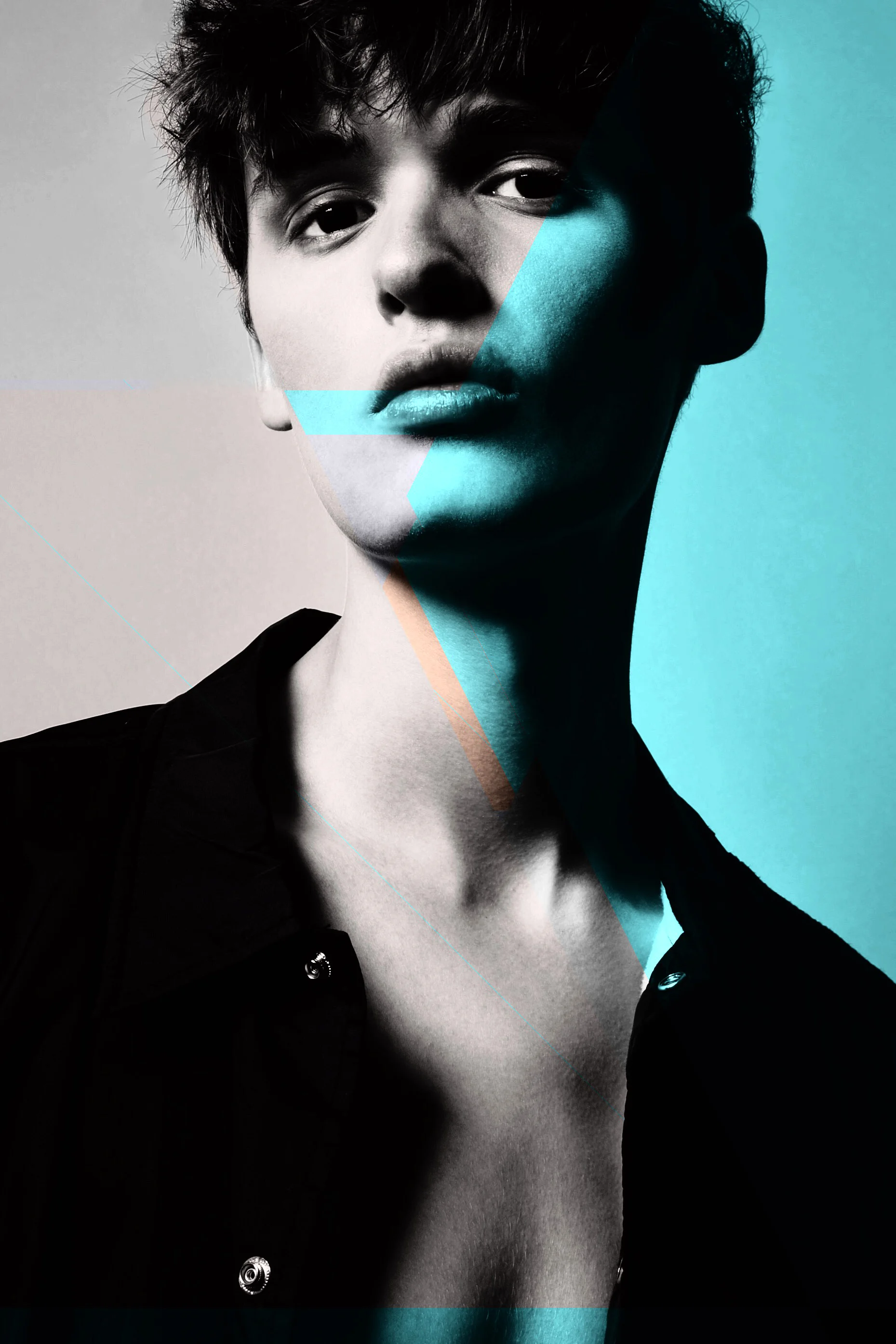 Black and white portrait of a young person with short hair, wearing a dark shirt, with colored geometric overlays on the face and neck, and a blue background on the right side.