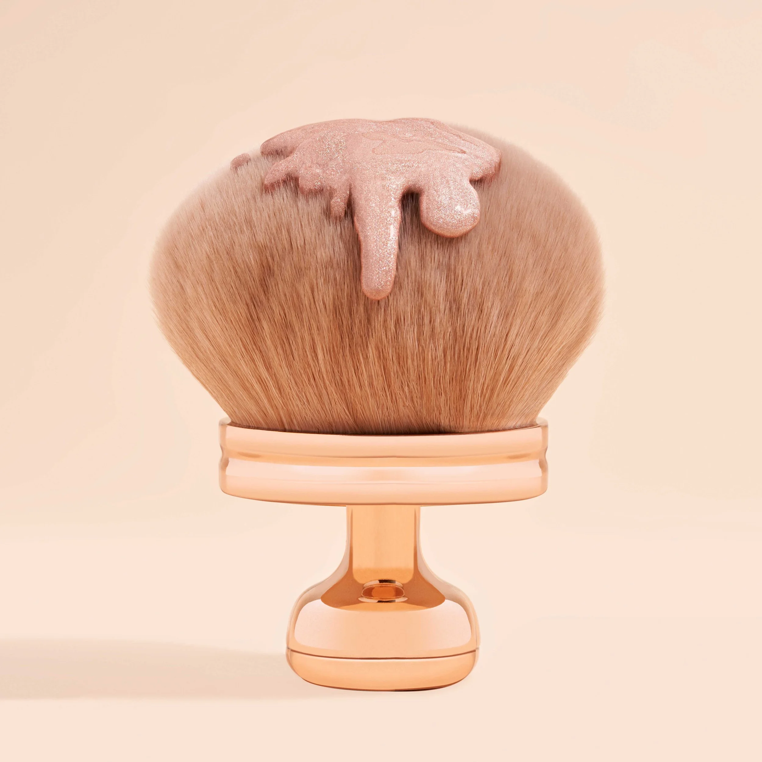 A makeup brush with fluffy bristles and a pink handle, topped with pink glittery liquid or gel.