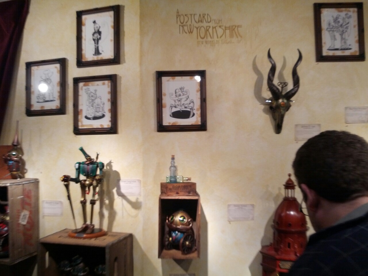 I went to New York City a few days before NYCC and was able to go to some of the designer toy shops. One of which was My Plastic Heart. For such a tiny little place it sure does make quite an impression on the toy scene. I happened upon Doktor A setting up his show “Postcard from New Yorkshire”. I came back a few days later for the opening and was very impressed. The pieces are a combination of customs and originals with found objects. They all fit seamlessly into his Mechtorians world.
You can see the pieces up close on the MPH website and his own blog.