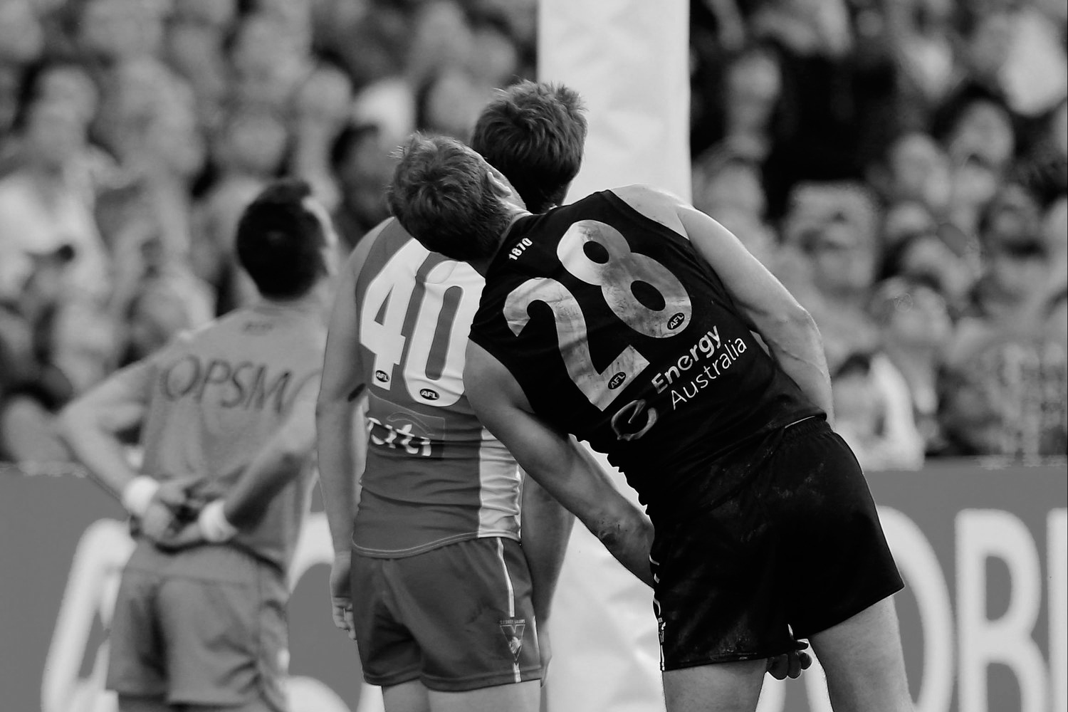Nick Smith of the Swans and Jay Schulz of the Power tilt their heads conversely as they follow the flight of the ball towards the goal posts during the 2014 AFL Round 13 match between the Sydney Swans and Port Adelaide Power at the SCG.