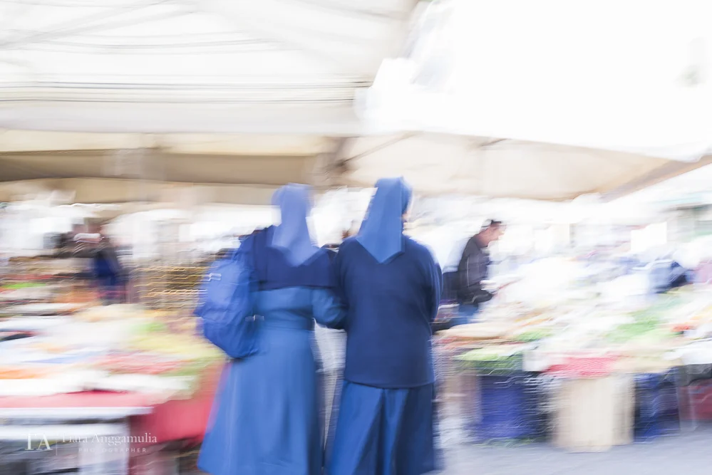 Nuns strolling in Campo de Fiori market.