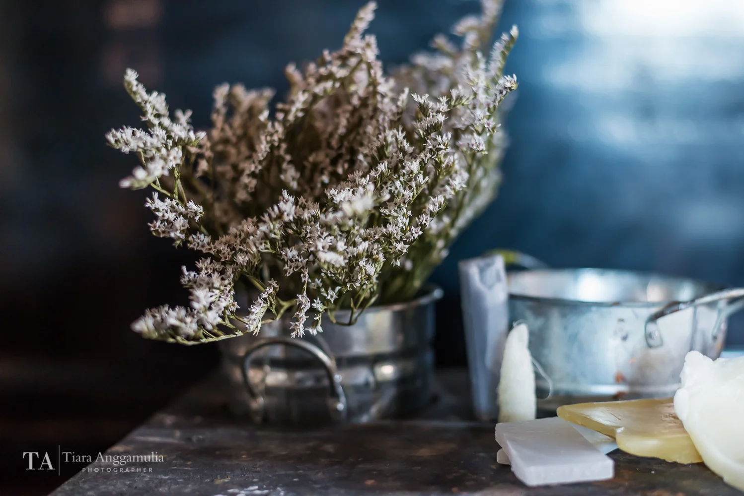 Flowers in a tin pot and wax.