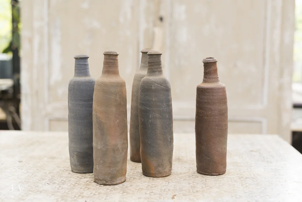 Assorted ceramic bottles inside Petersham Nurseries shop.