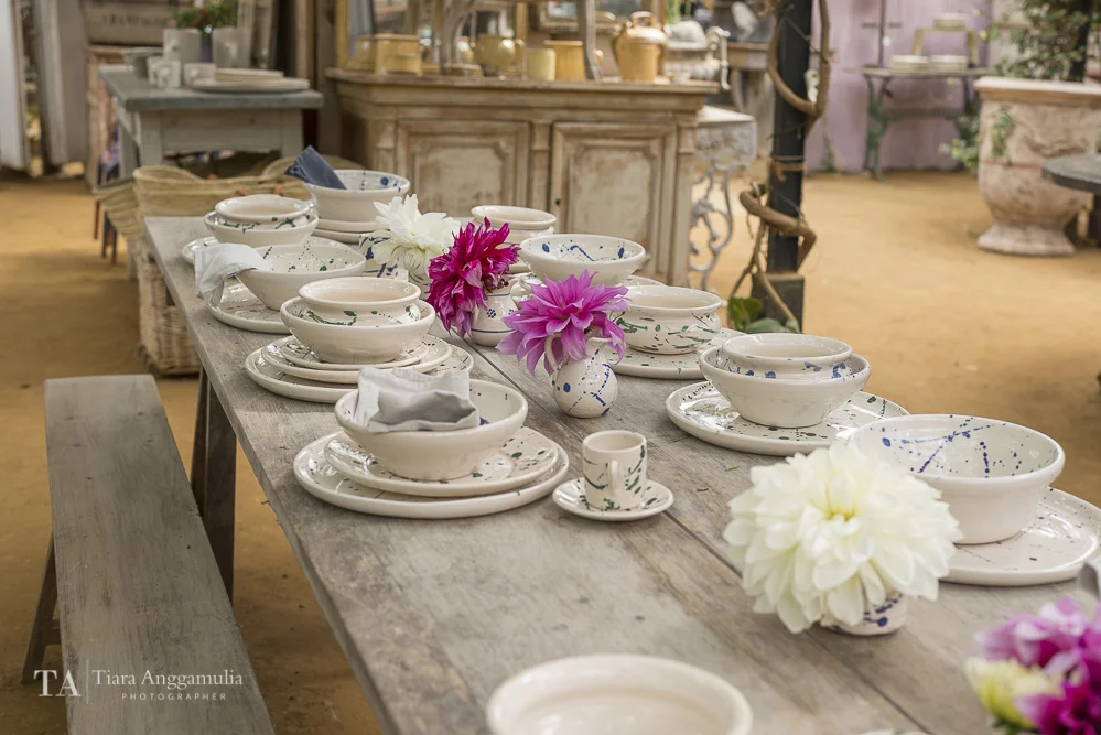 Dining table with Italian tablewares inside Petersham Nurseries shop.