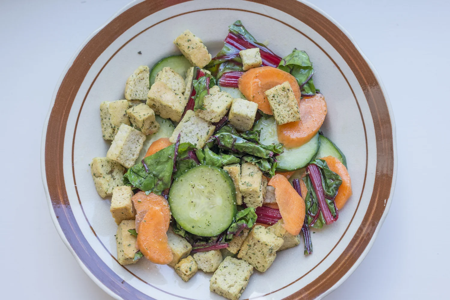 A salad of red chard carrots cucumber and garlic croutons with extra virgin olive oil.jpg