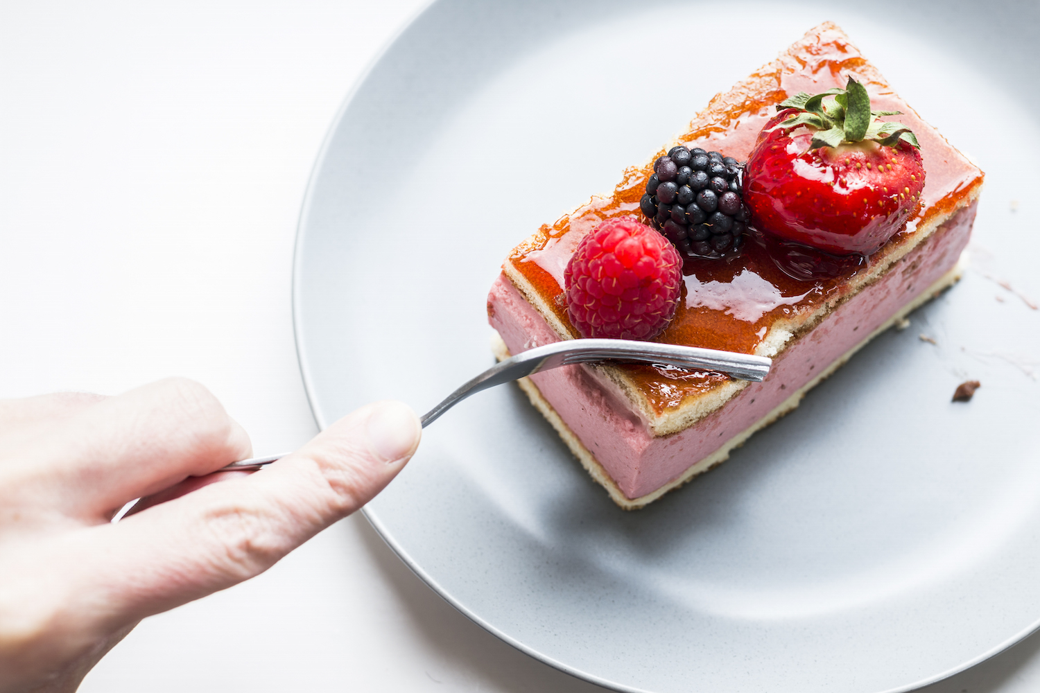 Cutting a mixed berry mousse cake.jpg