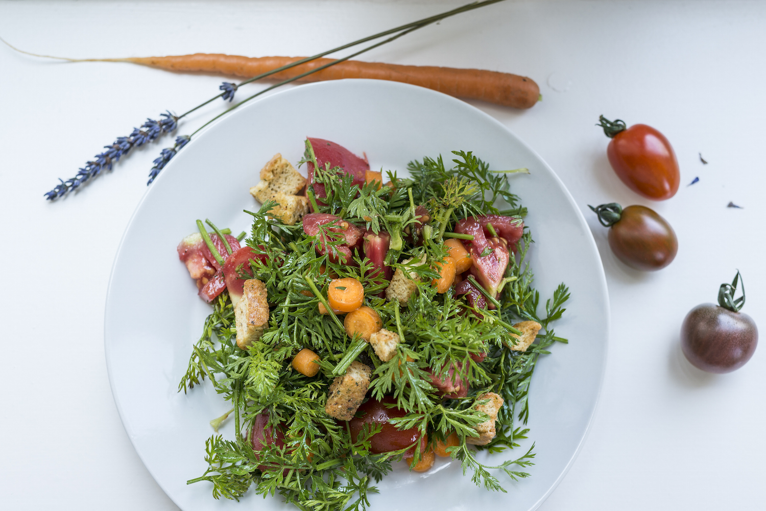 Salad with carrot leaves tomatoes carrots and croutons.jpg