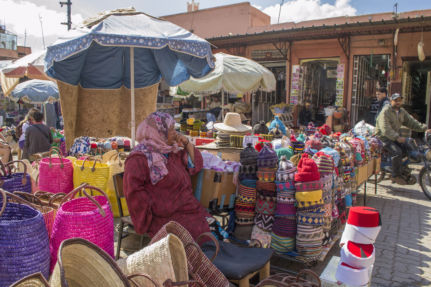 A market vendor selling handcrafts in Marrakech souks.jpg
