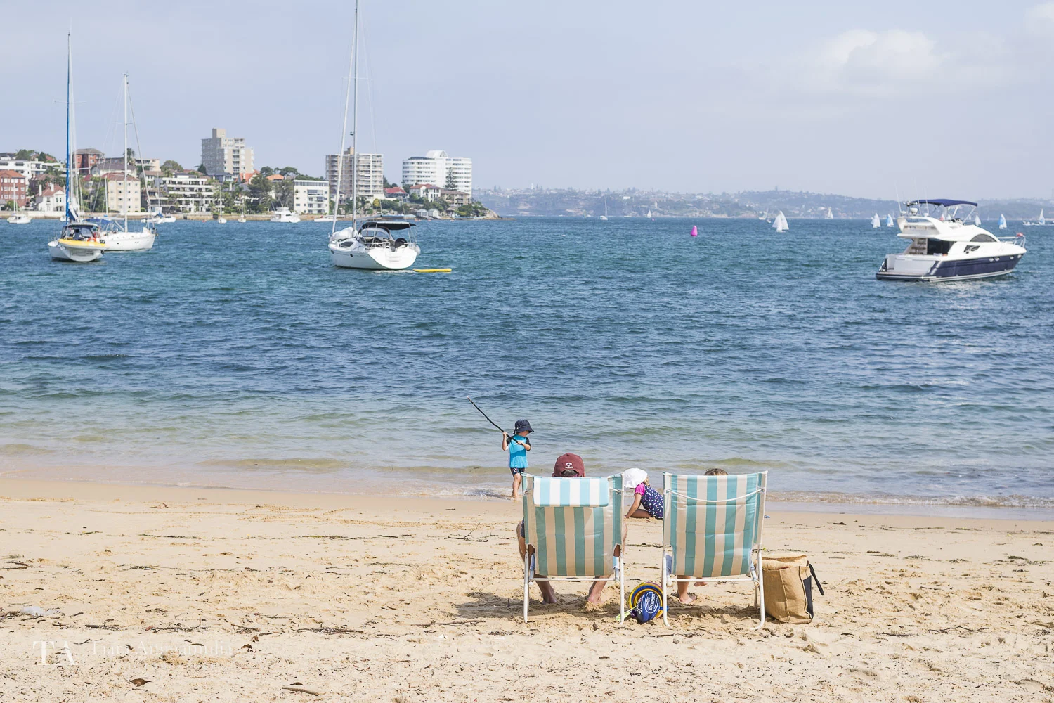 A family relaxing on Manly beach.