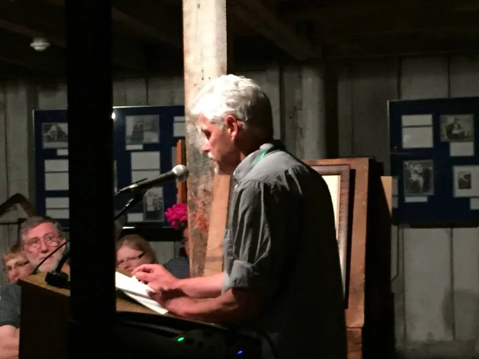 Faculty member Alfred Nicol reads his work