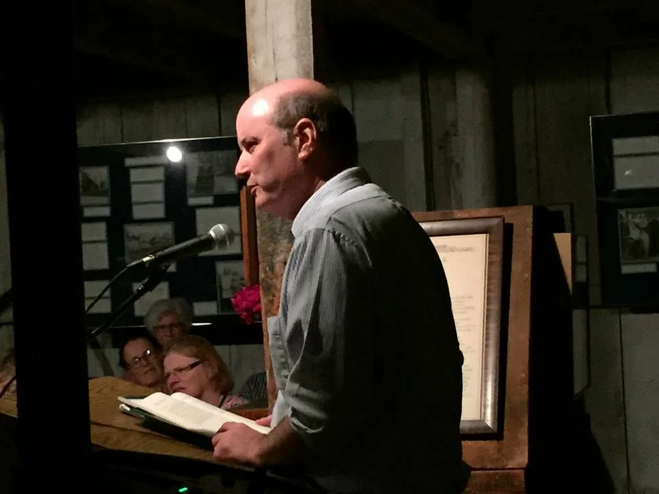 Falculty member A.M. Juster reads his work