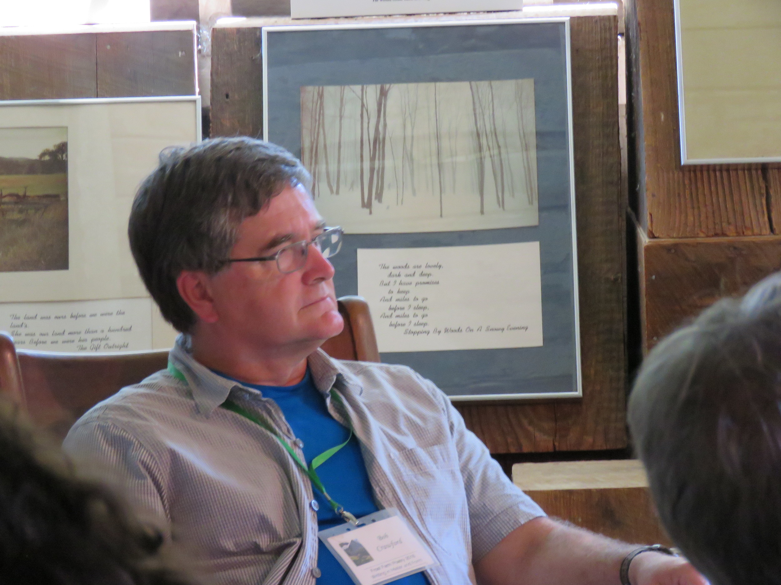 Frost Farm Poetry Director Robert W. Crawford listens to students read their poetry