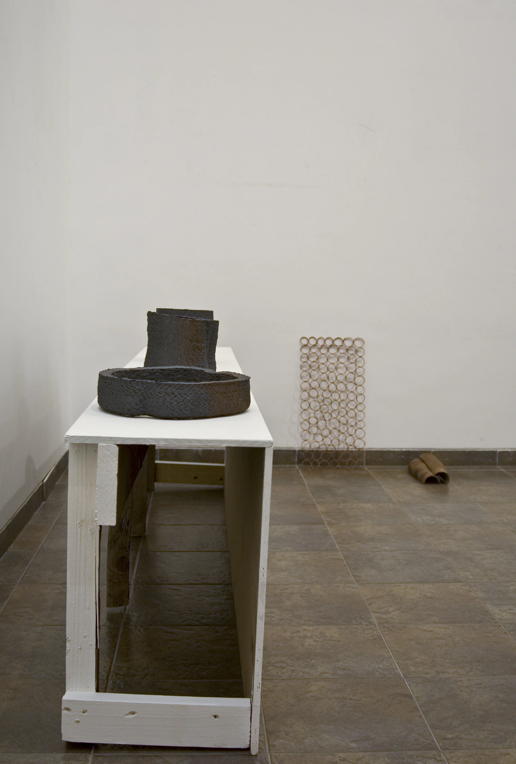 (Installation View) Terra Cotta, found and altered architectural fragment (wooden fence), paint, architectural fragment (roof tiles).