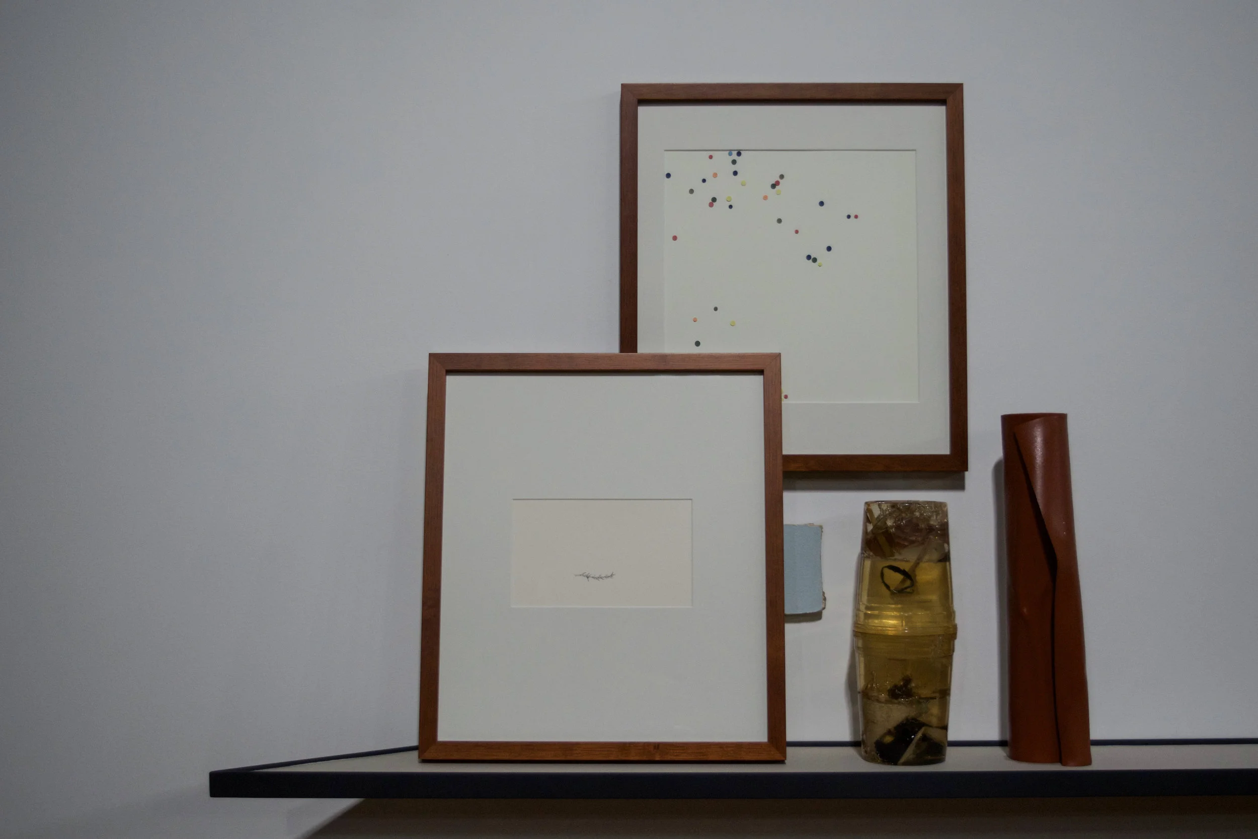 The Mantle, The Home, and The Window. (detail: The Mantle) framed graphite rendering of abscised tumbleweed part, framed collage of porcelain confetti, section of sheetrock from childhood bedroom, resin cast quart containers with studio detritus, collected brick from abandoned sites cast as rolled carpet the equivalent weight of one brick. 2016
