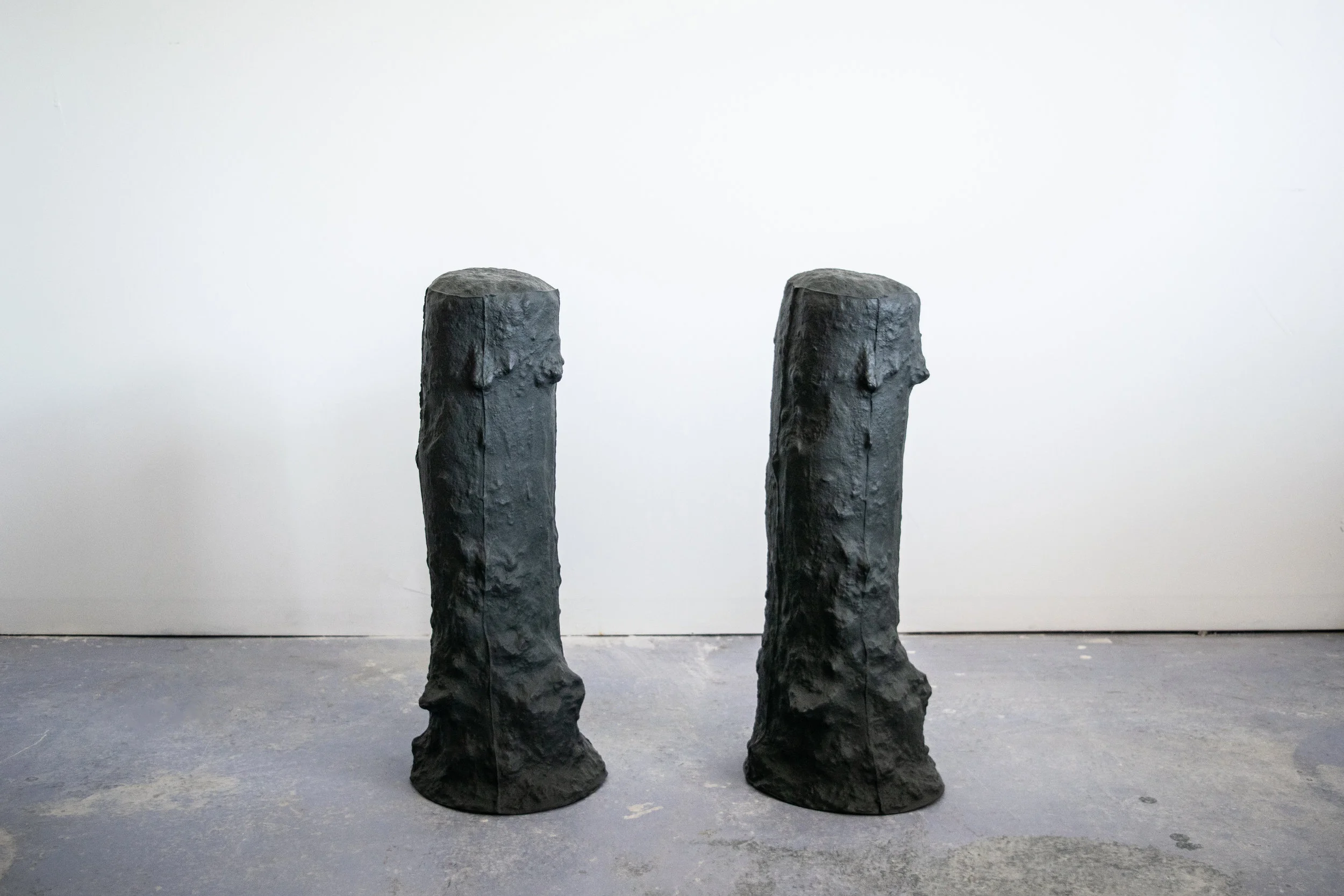 terrain and territory , slip cast black porcelain with glazed interior 10” diameter x 28” tall. 2018 terrain and territory focuses on the potent space of the fence post hole as a metaphor, and commentary against the current administrations determination to construct false narratives and divisions around issues regarding immigration, and "us" and "them” mentality. By pulling the subterranean space of the hole up and out of the ground as a hollow ceramic form, it shifts the functionality of the space as container, rather than divider, and placed; seeks to call into attention the skin of this often over looked space. The extension of a fences intention, to delineate, is further implied in the gallery by constructing an implied border between the two forms set in the space.