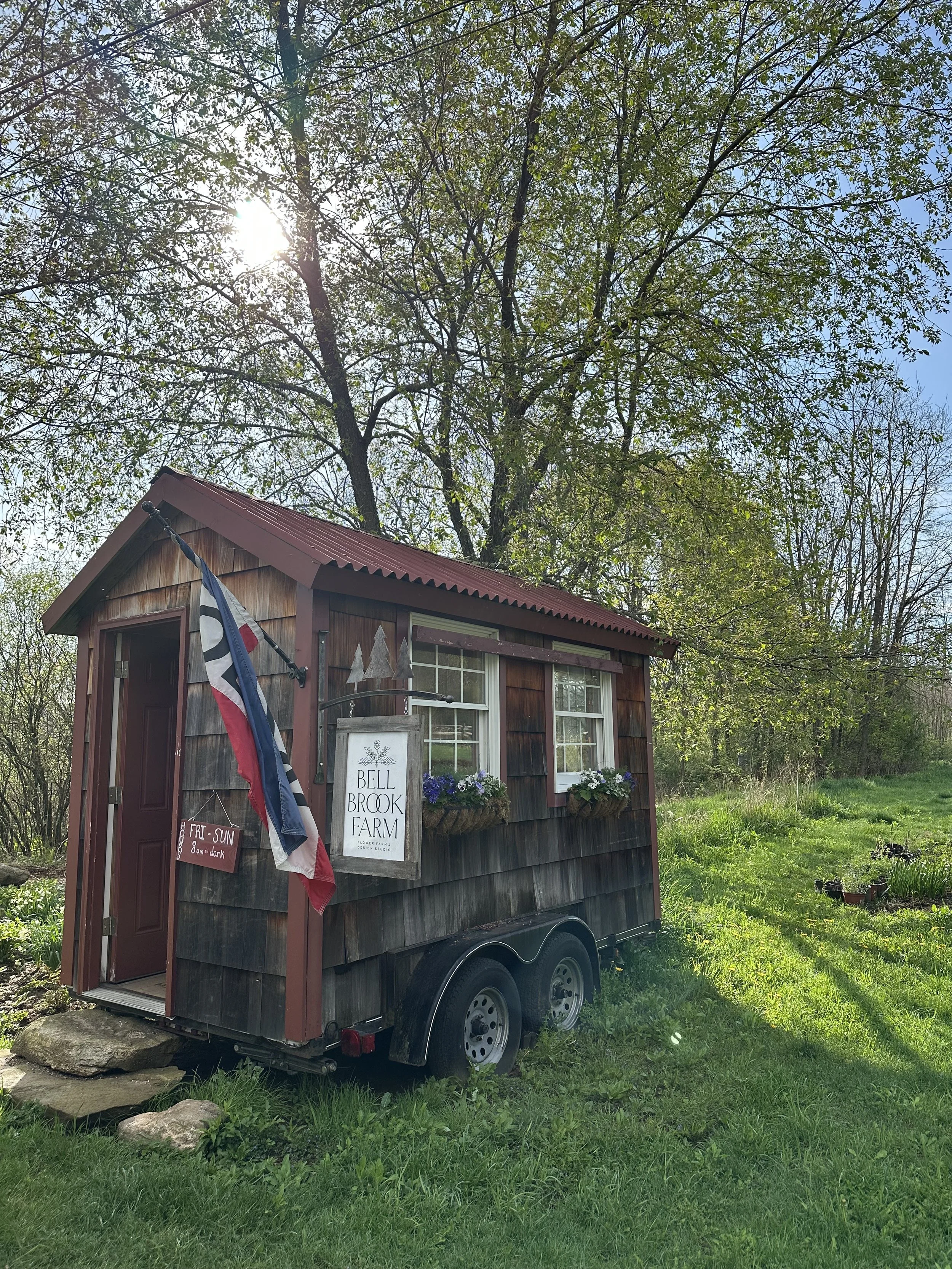 farm stand with open flag on sunny day in spring