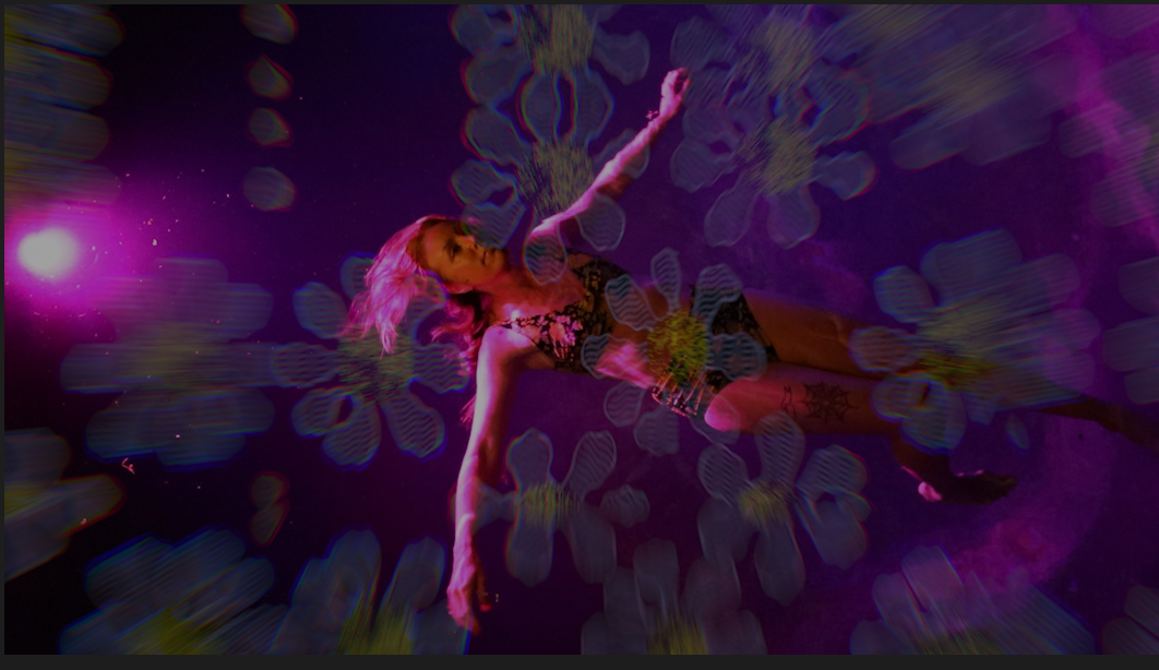 woman doing the back float in a magenta lit pool with a wiggly flower overlay