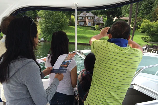 PICTURED ABOVE: Cunningham used Dean Jones's photo in the article, writing that “ Realogics Sotheby’s International Realty reports a significant increase in Lake Washington waterfront tours with Asian homebuyers. Here, a family from mainland China explores a Hunts Point listing offered at $8.75 million.”