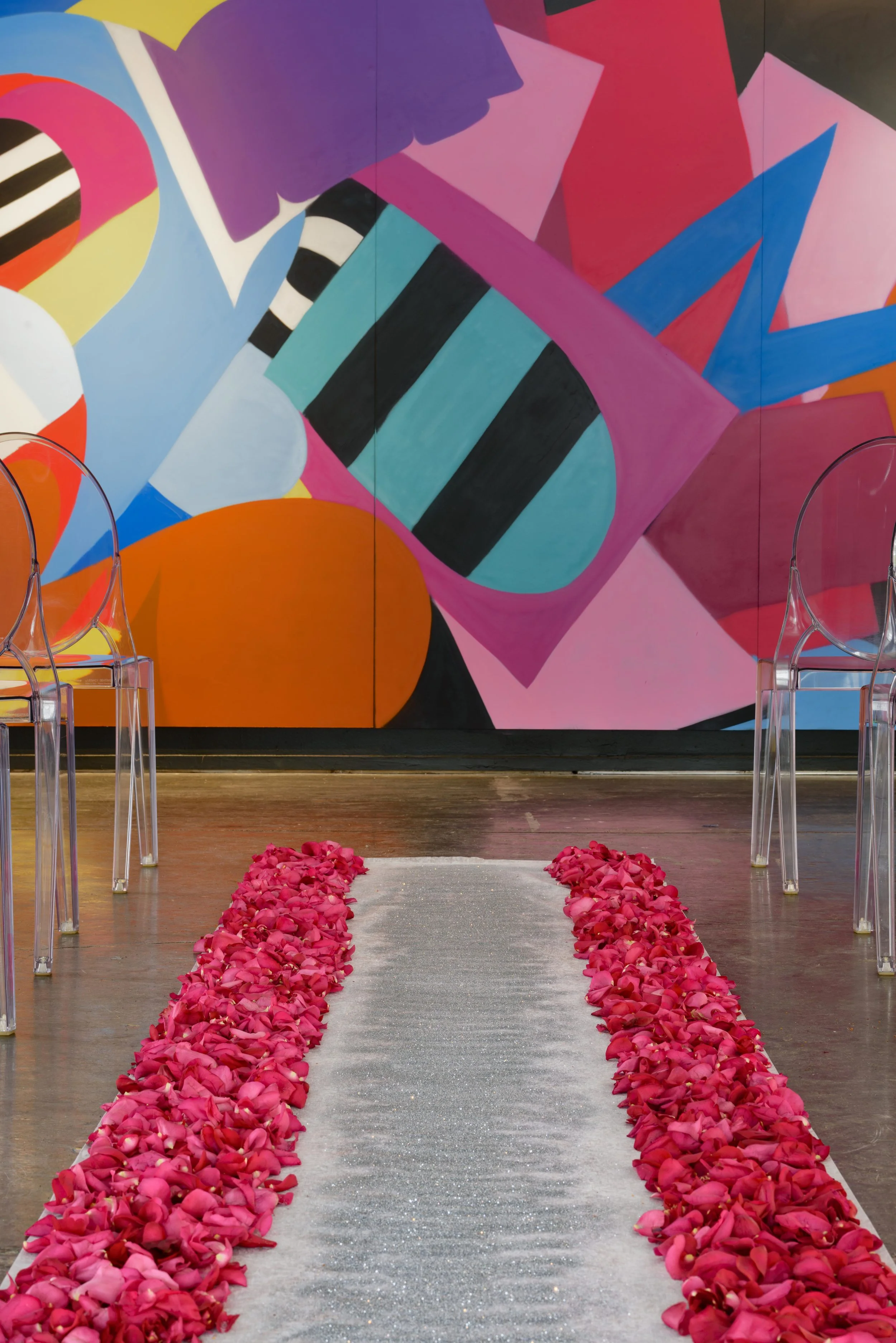 A 30ft Inkala, graffiti inspired mural is the backdrop for the ceremony.