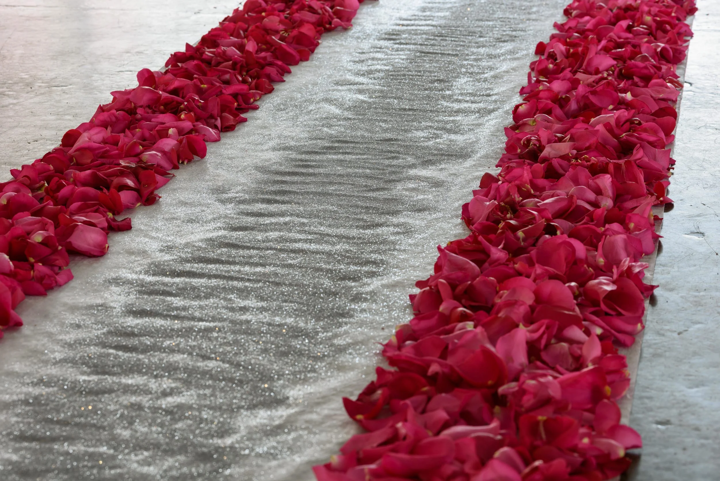 Custom aisle with sculptural element designed in glitter.