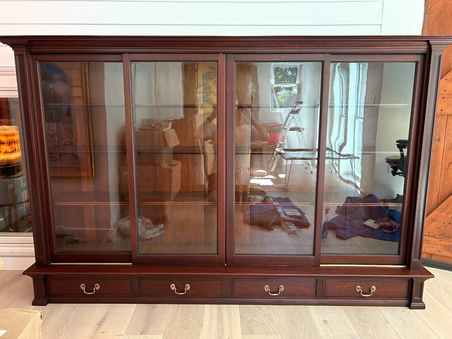 After an extensive restoration involving everything from structural reinforcing, mildew remediation, custom matching trim profiles, replacing shelves, sourcing vintage brass rollers, and lots of meticulous color matching and refinishing, this massive