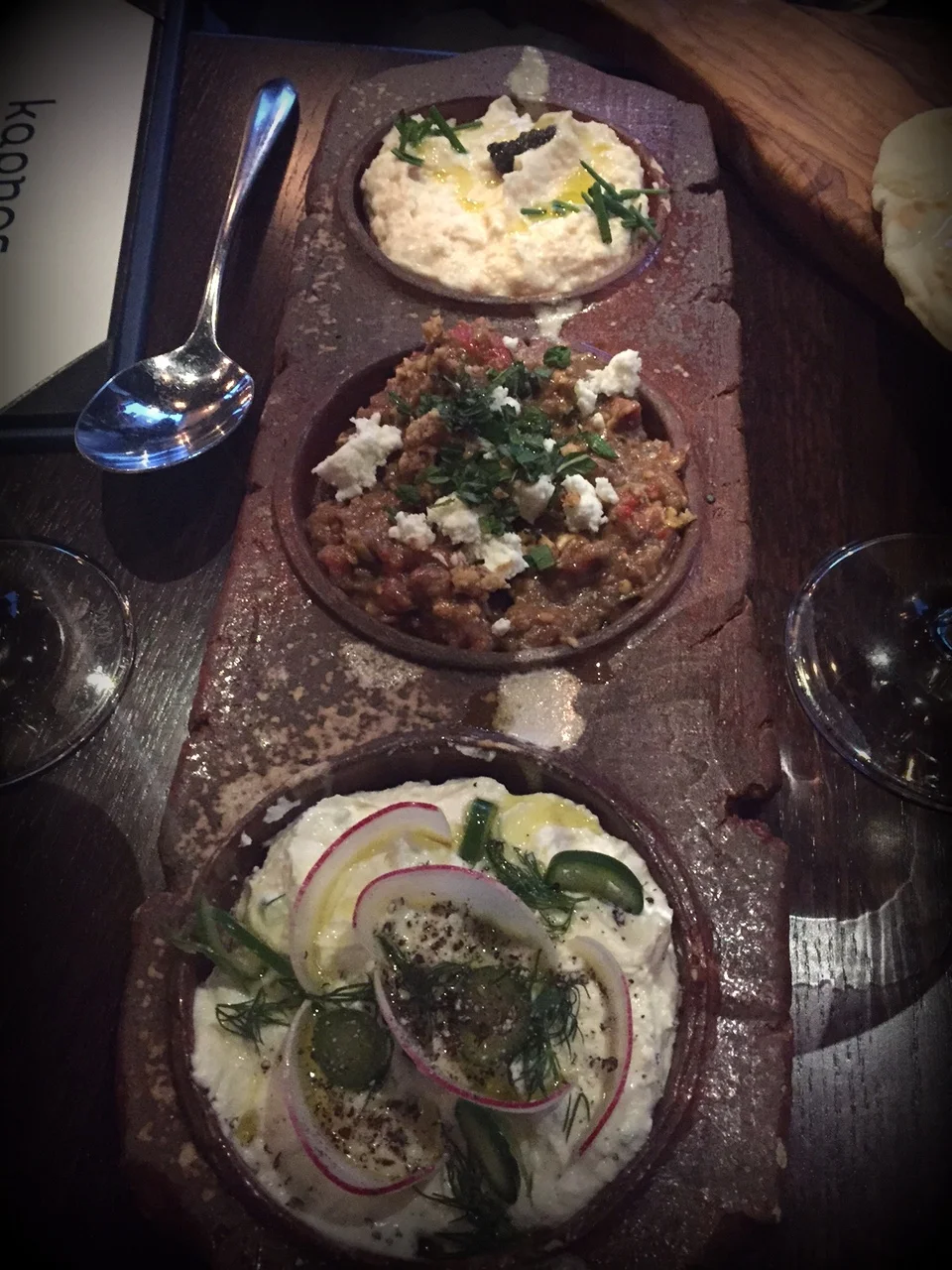 3 spreads: taramasalata made with carp roe, caviar and cauliflower;&nbsp;melitzanosalata (smoky eggplant, walnuts, feta and roasted sweet peppers); and&nbsp;tyrokaftari (feta, manouri, and grains of paradise)