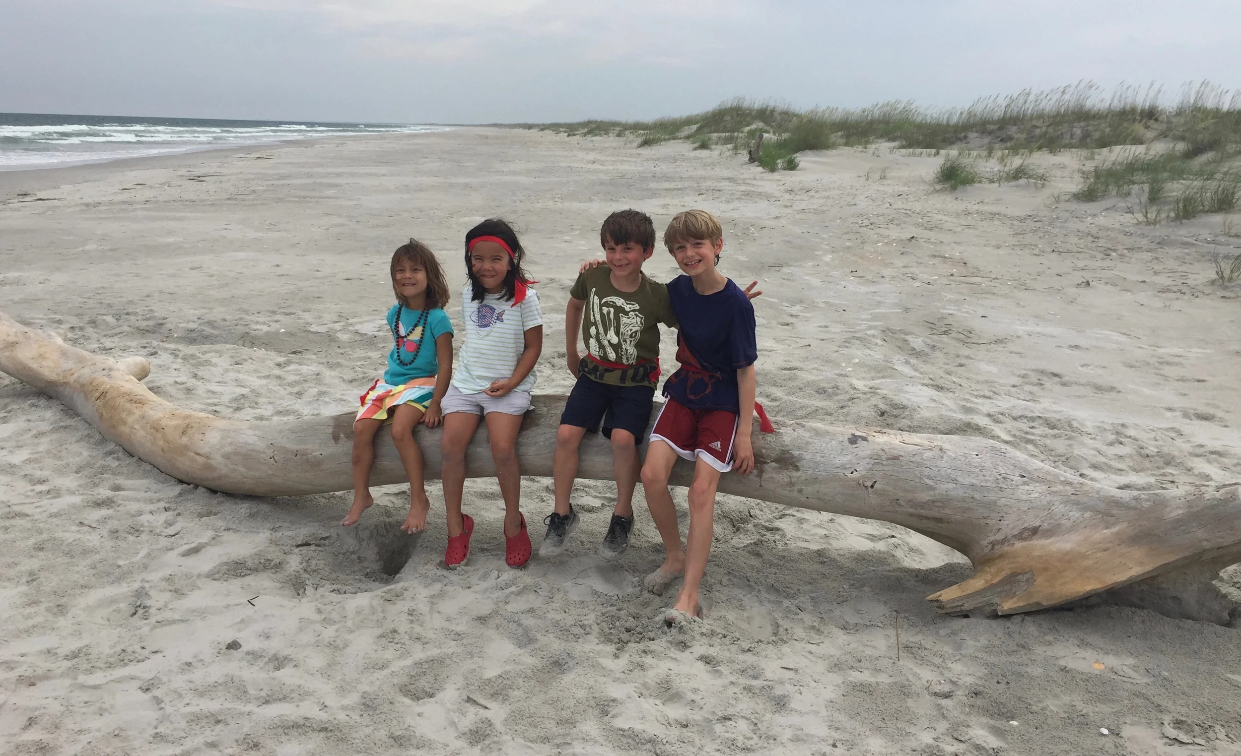 Cousins on a sizeable piece of driftwood