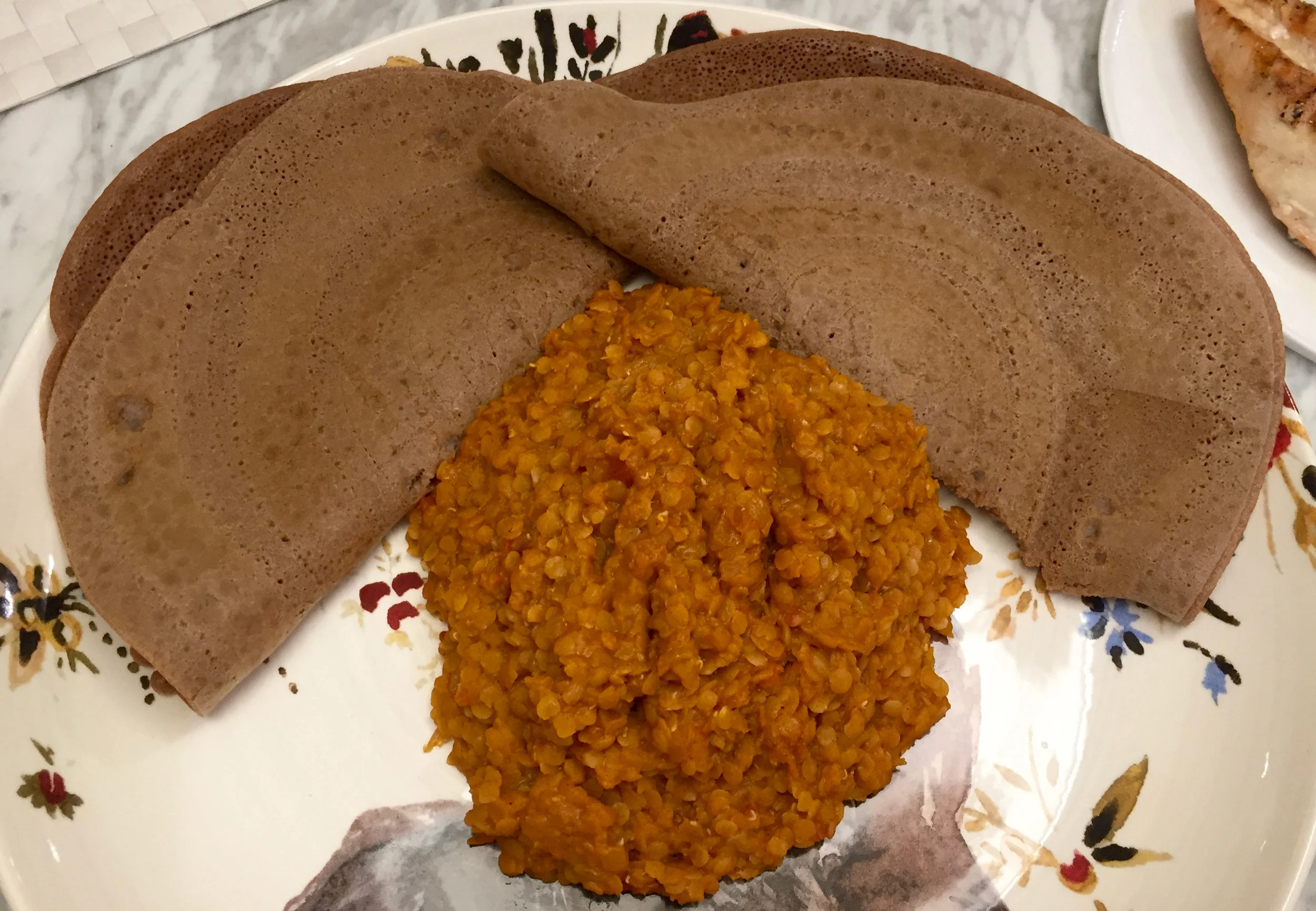 injera made from both brown and ivory teff, and red lentil wat