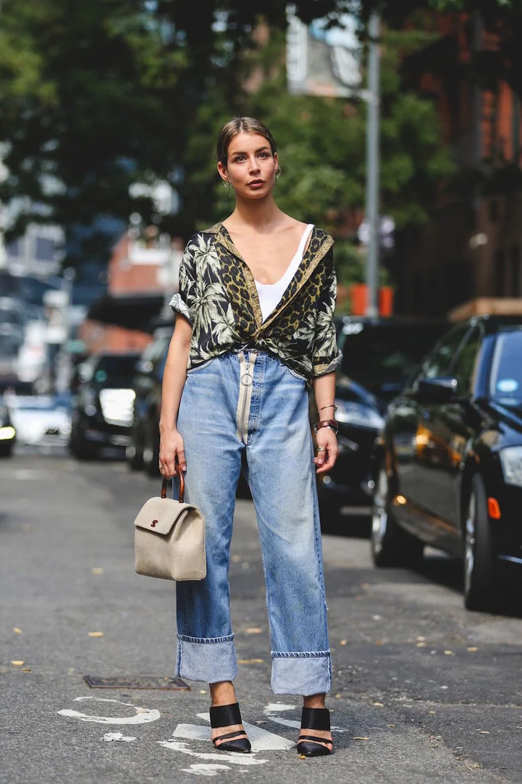 Wide leg trousers are making a comeback, and I'm fully behind the immersion of the style into denim. They're comfortable, flattering, and when paired with a drape-y patterned button down, just the right amount of sexy. The pointed toe on the shoe perfectly contrasts the shapelessness of the pants, and the light basket-like handbag softens up the entire look.
