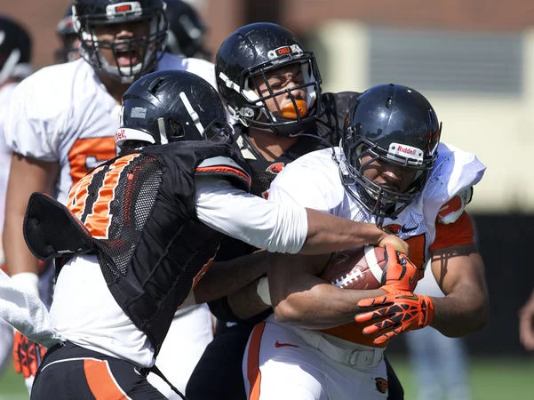 Damien Haskins Getting Tackled by 2 Defenders Spring 2014.jpg