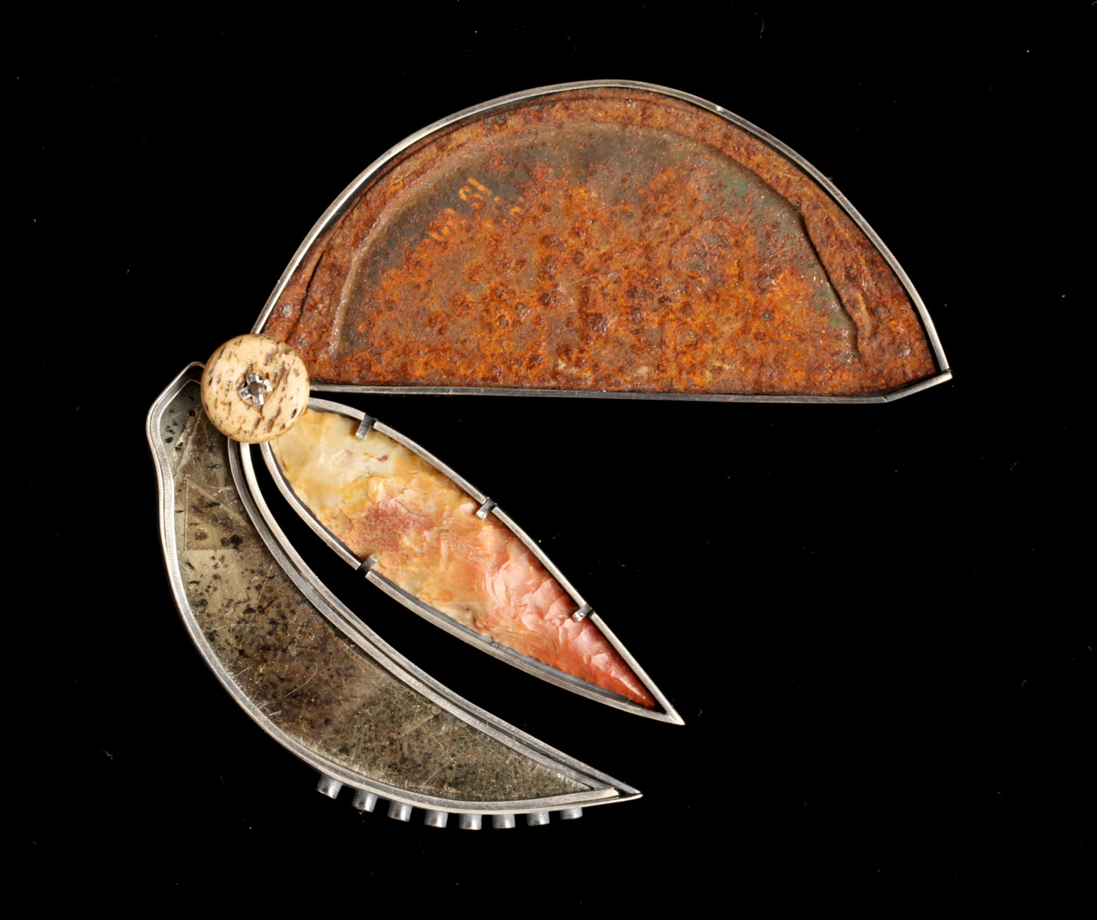 SECATEUR of silver, stone, bone, rusted can lid, 7.62 x 8.89 centimeters.