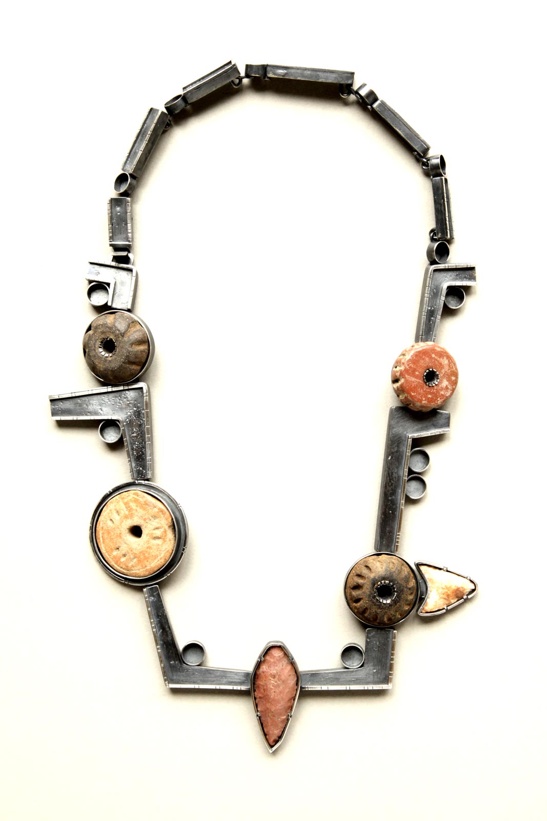 STONES AND WHORLS neckpiece of silver, Guatemalan clay spindles, stone, 30.48 x 16.51 x 1.27 centimeters.