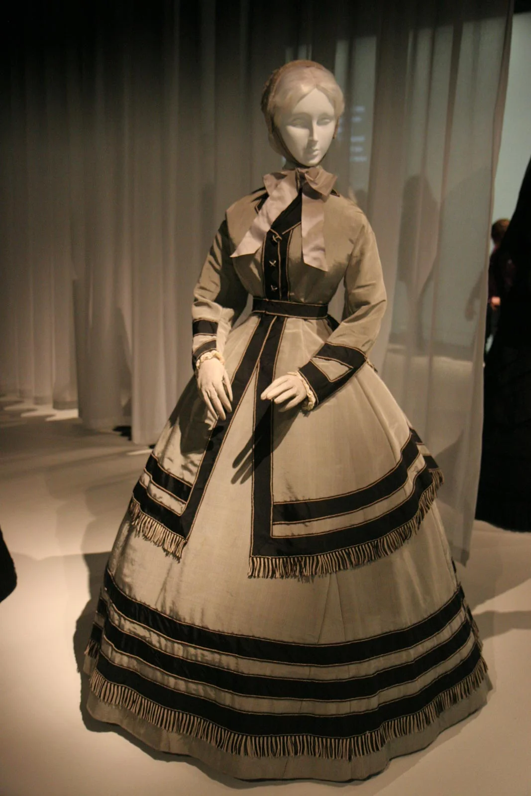 Gray silk wool poplin, black silk faille, black and white silk cording and fringe make up an American wedding ensemble from 1868.