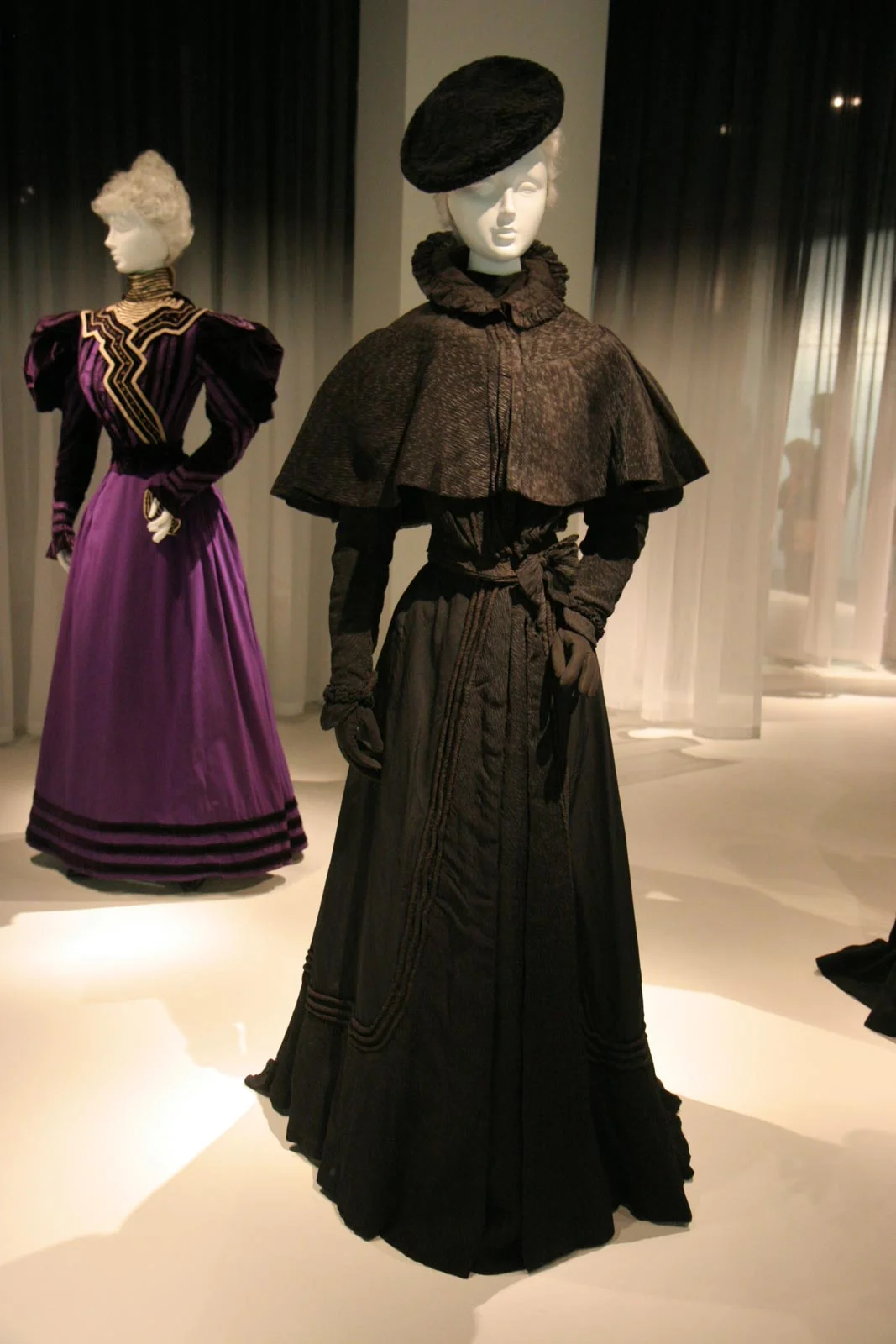 The emergence from deep black to glossy black to browns and grays is another indication of leaving mourning.