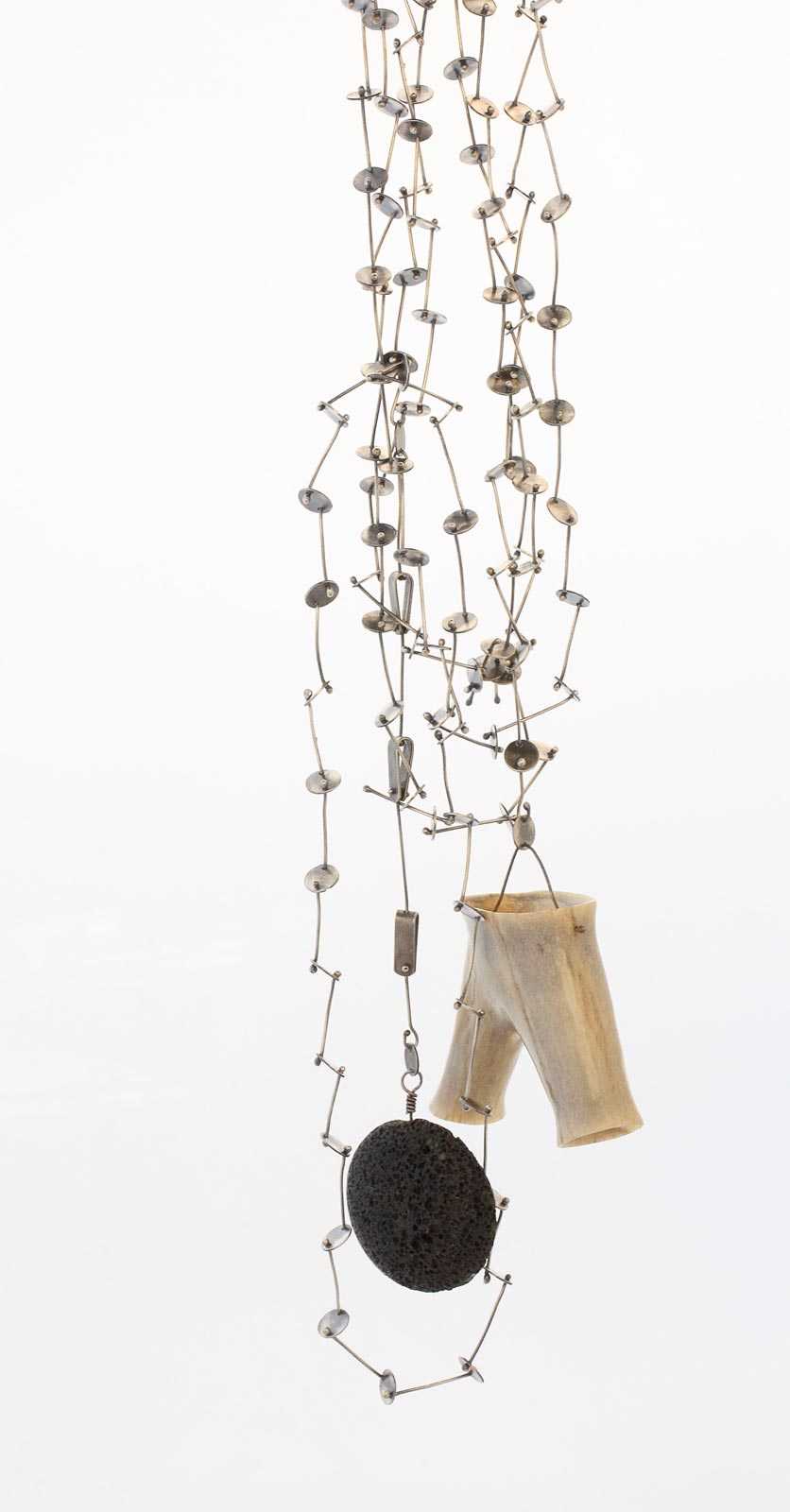 NECKLACE of shed deer antler, sterling, lava, 7.6 x 182.9 x 2.5 centimeters, hand-carved, hand-fabricated chain, 2014. Photograph by Shana Crawford.