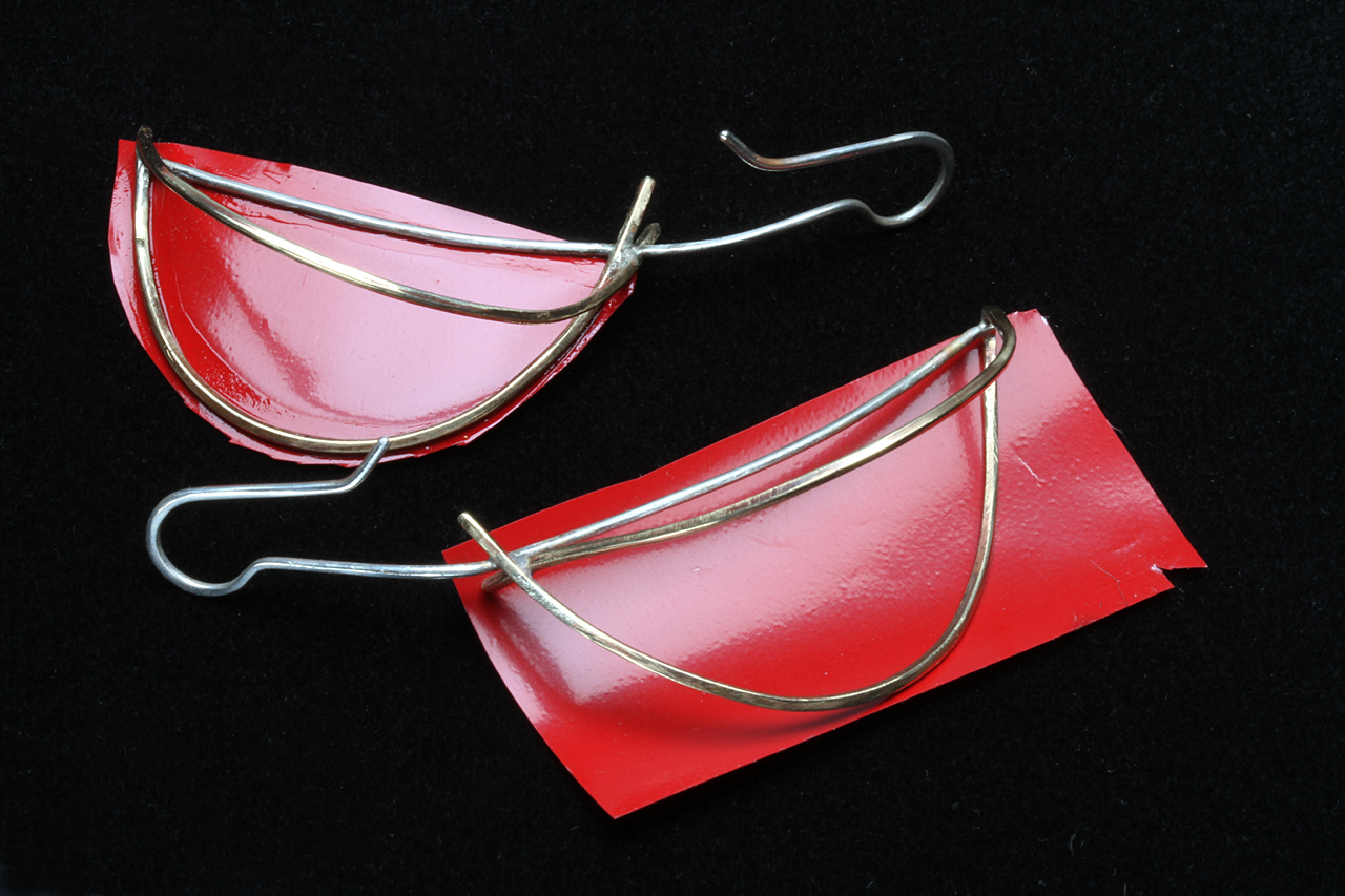 TWO-SIDED FRUIT SLICE MATRIX EARRINGS, one with Ultracote adhered with cyano-acrylic glue, and trimmed to shape, while other is just laid on the covering. Trimming covering to shape of earring wire matrix results in better gluing and less buckling when heatshrunk.