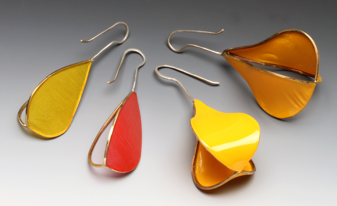 POD MATRIX EARRINGS WITH ONE COVERLITE PANEL AND FIG/PEAR-SHAPE MATRIX EARRINGS WITH TWO ULTRACOTE PANELS, from 2014/2015, demonstrating matte and shiny surfaces respectively, as well as how they react to heat. Heatgun on highest setting used for both. Fig/pear-shaped earrings are 7.2 cm high. All my earrings are supposed to be worn with open end of earwire facing inward. These were photographed with a macro lens, with studio strobe, on a Varitone background (Liu 2014b).