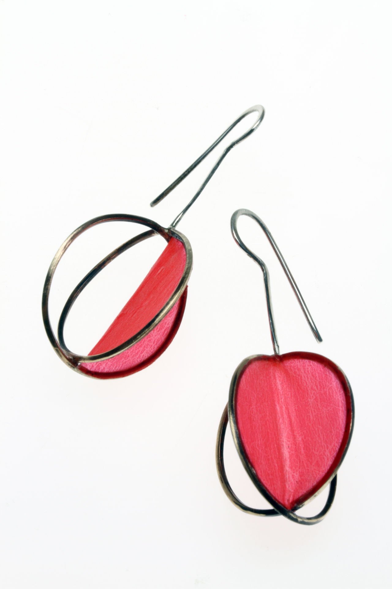 CROSSED COIL MATRIX EARRINGS, with one panel of Coverlite covering, are 5.4 cm high, 2015. The Coverlite conforms to the planes of the panel and is a matte finish. The brass wire was annealed, then wound on a wood dowel, much like one would make large jump rings. Nipped apart, ends filed square and soldered to form two crisscrossed rings. These are photographed with both reflective and transiluminated light. My bamboo and matrix jewelry is carried by Freehand Gallery, in Los Angeles.