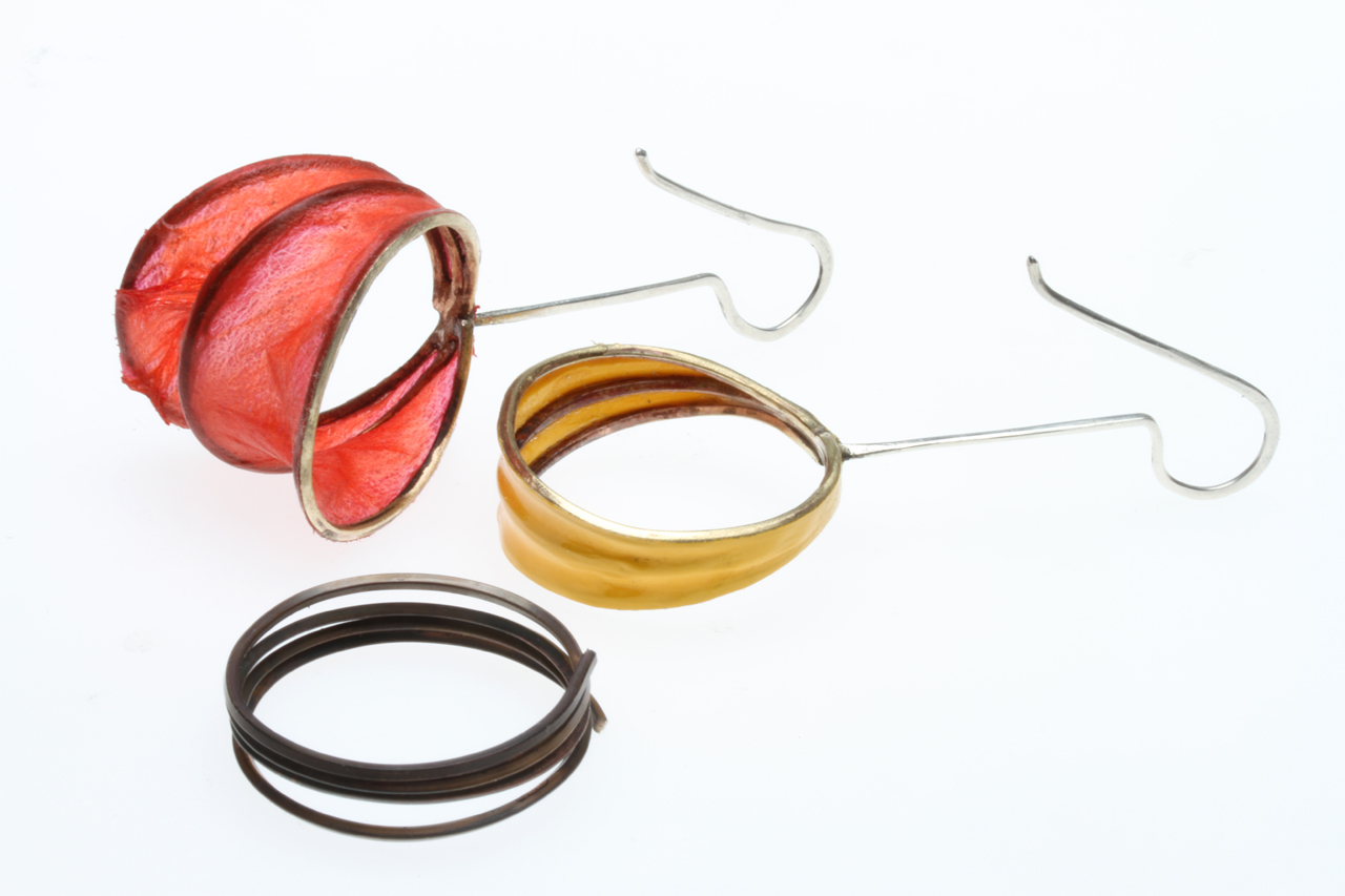 COMPARISON OF COIL EARRINGS WITH COVERLITE OR ULTRACOTE, where they are soldered together at the top to the silver earwire. Then the bottom is spread or pulled apart. The dark, wound brass coils used to form the matrix have been formed on a wood mandrel, then annealed so that they are easier to work.